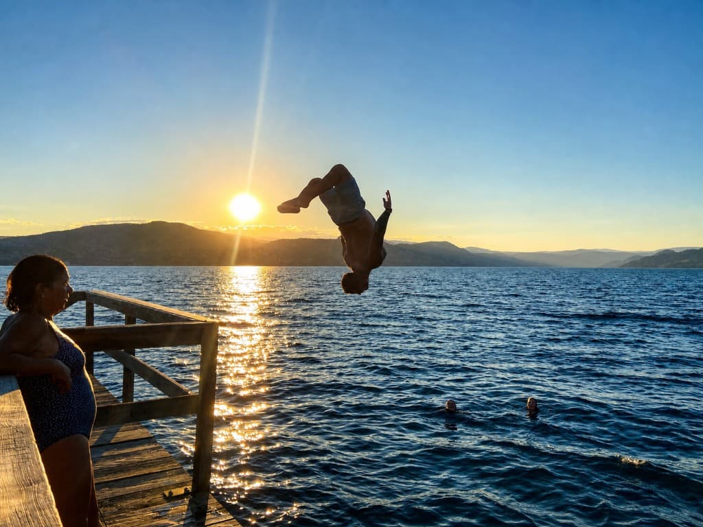 Backflip off a dock into Okanagan Lake at golden hour